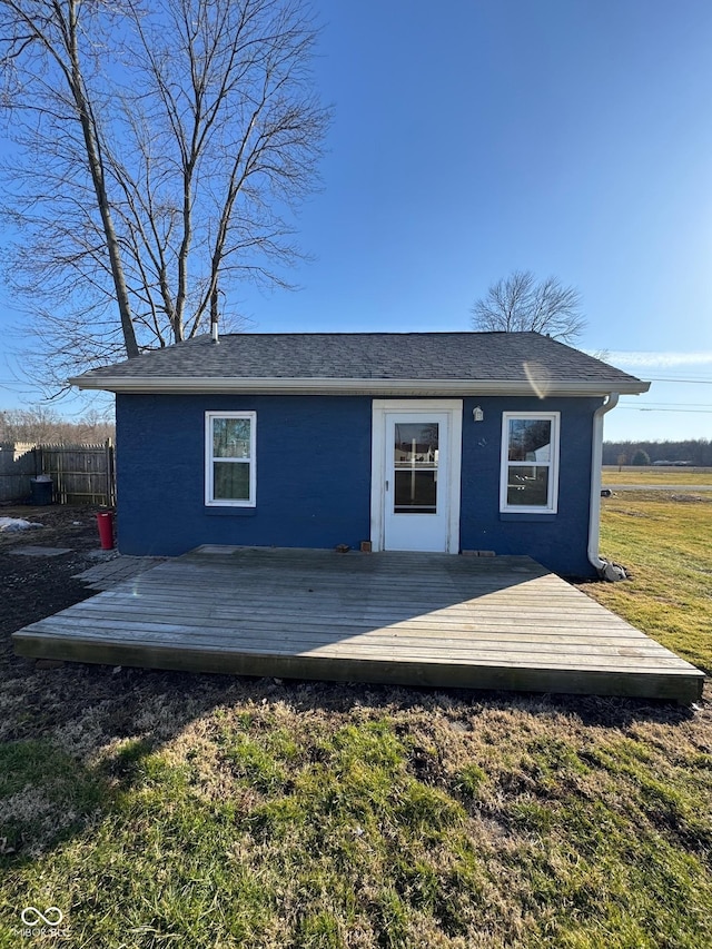 view of outbuilding featuring fence