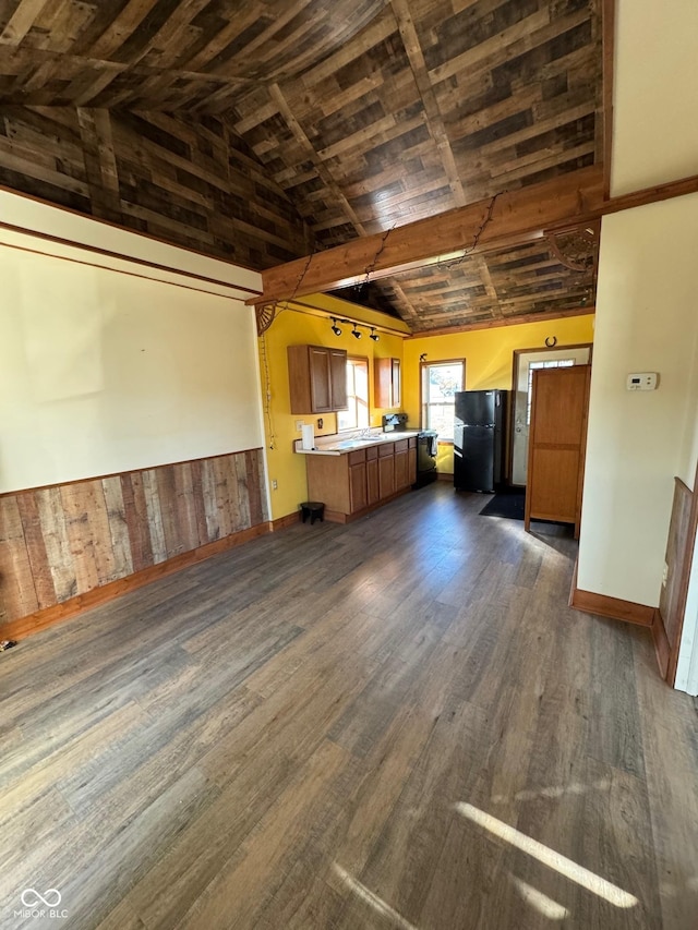 kitchen with dark wood finished floors, light countertops, brown cabinets, wooden ceiling, and freestanding refrigerator