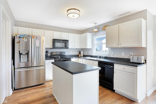 kitchen with dark countertops, visible vents, white cabinetry, and black appliances