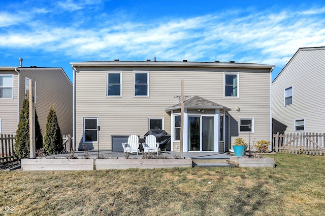 rear view of property featuring a yard, a fenced backyard, and a patio area