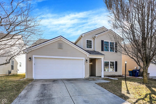 traditional-style home featuring concrete driveway, a garage, and a front yard