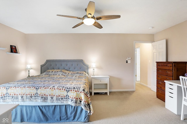 bedroom featuring a ceiling fan, light colored carpet, and baseboards