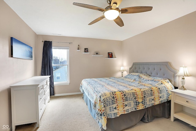 bedroom with light carpet, baseboards, and a ceiling fan