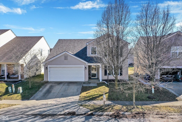 view of front facade with concrete driveway, an attached garage, a front lawn, and a shingled roof