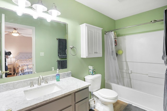 ensuite bathroom featuring shower / bath combo with shower curtain, toilet, vanity, ensuite bath, and a ceiling fan