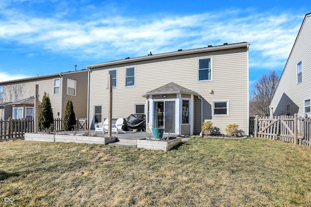 back of house with a patio, a fenced backyard, a yard, a sunroom, and a garden