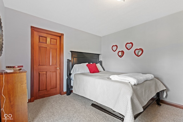 bedroom featuring baseboards and carpet