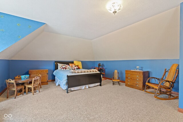 bedroom with baseboards, lofted ceiling, and carpet