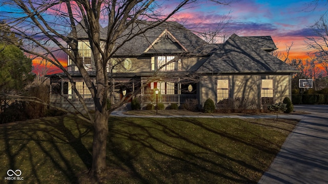 view of front of property featuring a lawn and a porch