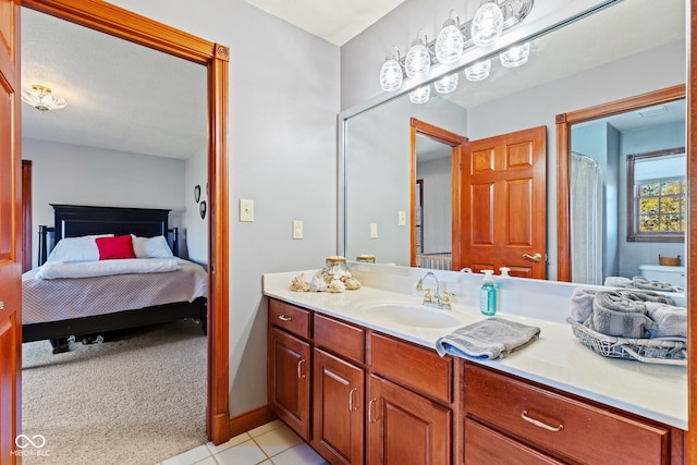 full bathroom with tile patterned flooring, connected bathroom, vanity, and baseboards