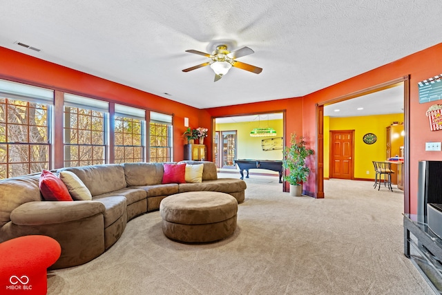 carpeted living room featuring visible vents, baseboards, a textured ceiling, billiards, and a ceiling fan