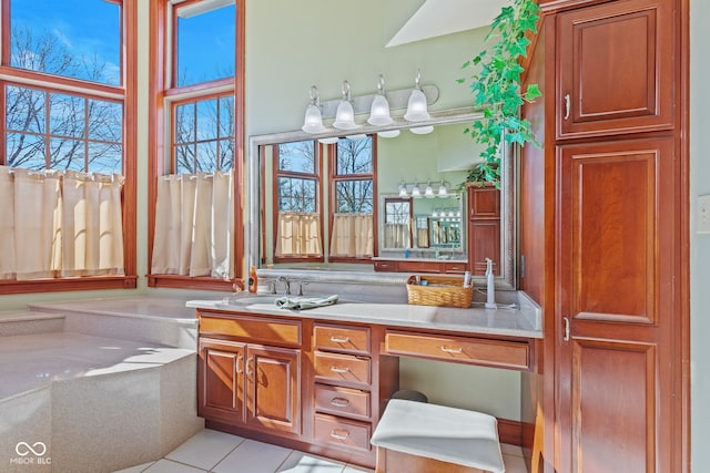 interior space featuring a bath, tile patterned floors, and vanity