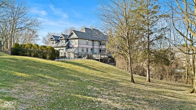 back of property featuring a yard and a wooden deck