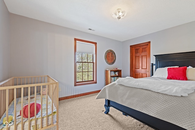 carpeted bedroom with visible vents and baseboards