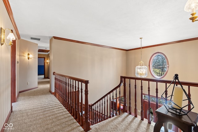 stairs with visible vents, baseboards, a chandelier, ornamental molding, and carpet flooring
