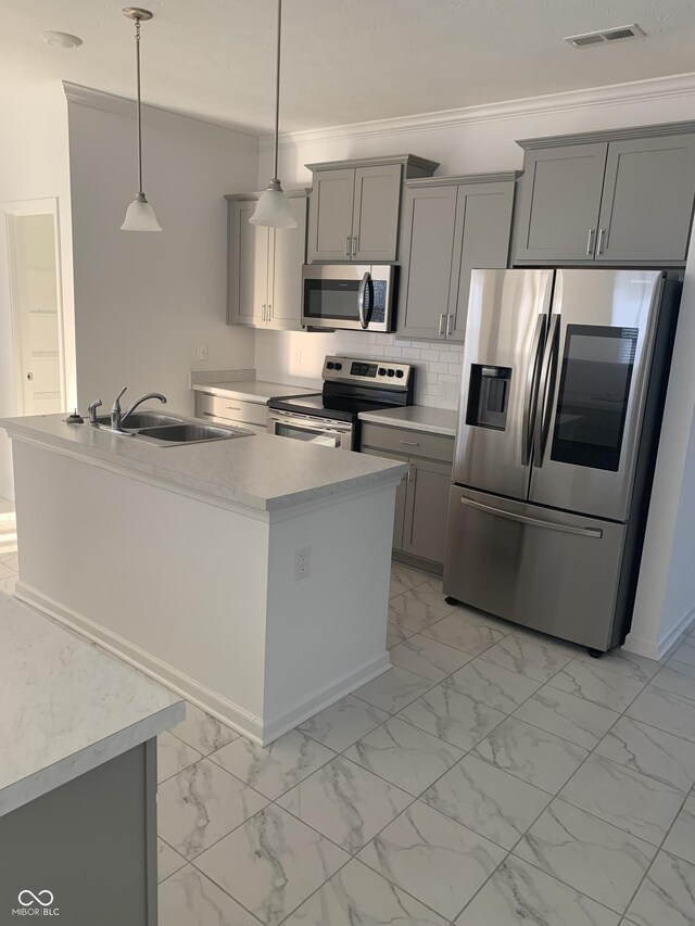 kitchen featuring crown molding, gray cabinets, marble finish floor, stainless steel appliances, and a sink