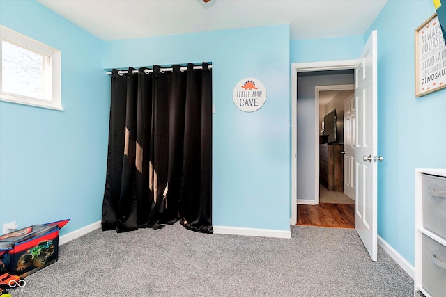 bedroom featuring baseboards and carpet floors