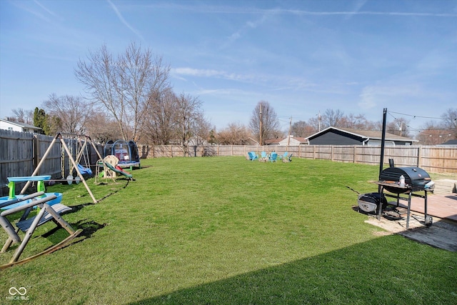 view of yard with a fenced backyard and a playground