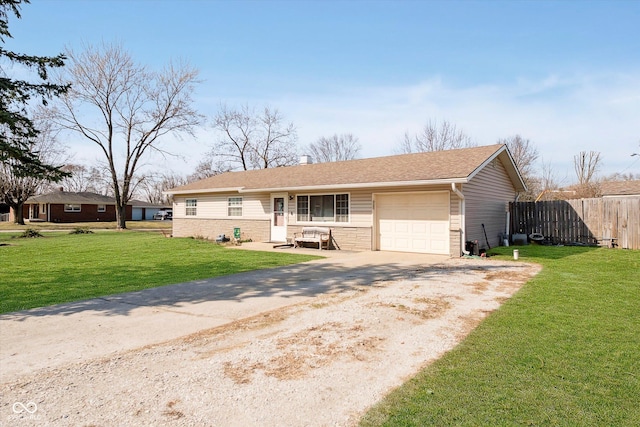 ranch-style house featuring a front lawn, an attached garage, fence, and driveway