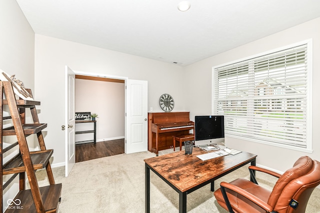 carpeted office space featuring baseboards