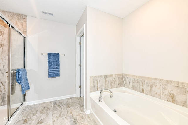 bathroom featuring a bath, visible vents, a shower stall, and baseboards