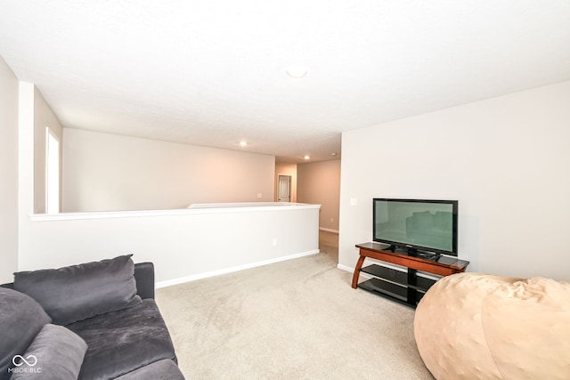 living area featuring recessed lighting, baseboards, and light carpet