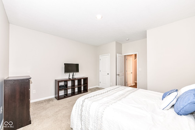 bedroom with baseboards and carpet