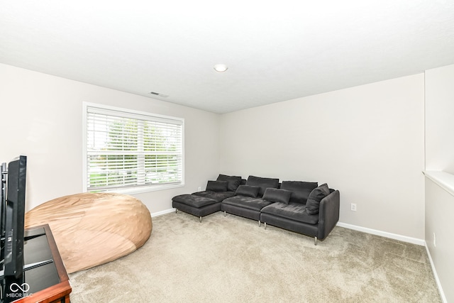 living room with visible vents, baseboards, and carpet