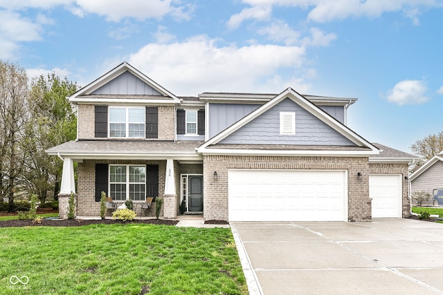 craftsman-style house featuring a front yard, an attached garage, brick siding, concrete driveway, and board and batten siding