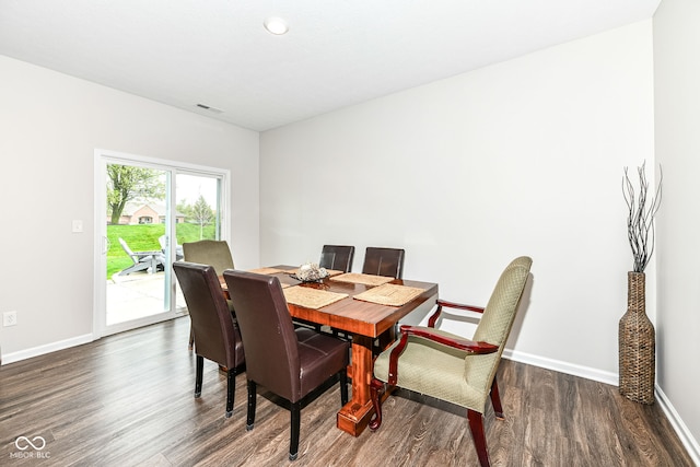 dining room with visible vents, baseboards, and wood finished floors