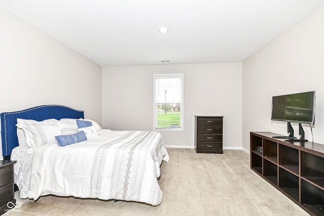 carpeted bedroom featuring visible vents and baseboards