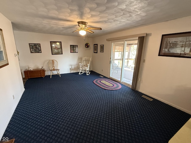 unfurnished room featuring baseboards, carpet floors, visible vents, and a ceiling fan