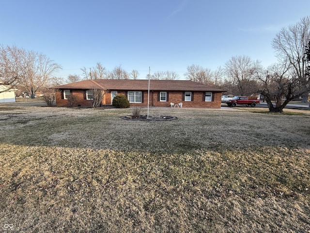 ranch-style home with brick siding and a front lawn