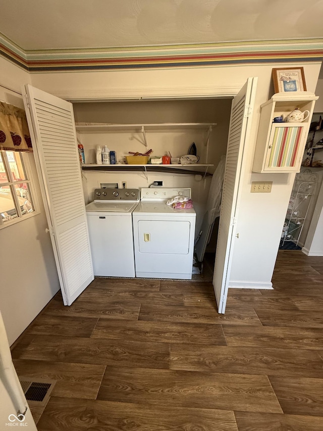 laundry room with washer and dryer, visible vents, dark wood finished floors, and laundry area