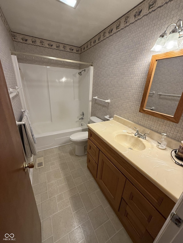 full bath featuring visible vents, vanity, toilet, and bathing tub / shower combination