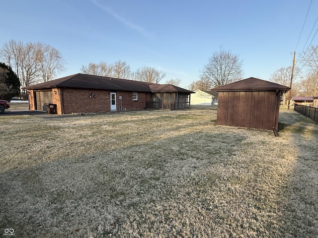 view of home's exterior with a storage unit, brick siding, and an attached garage