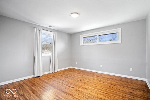 interior space featuring baseboards and wood finished floors