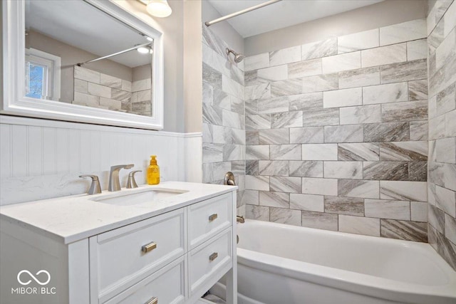 full bathroom with wainscoting, vanity, and  shower combination