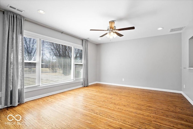 empty room with recessed lighting, visible vents, baseboards, and wood finished floors