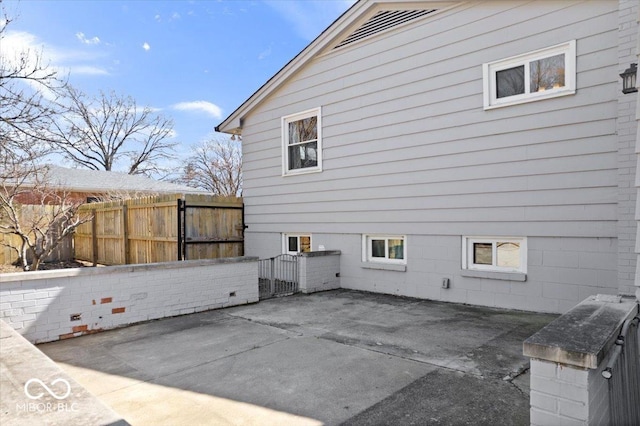 view of side of property with a patio area and fence