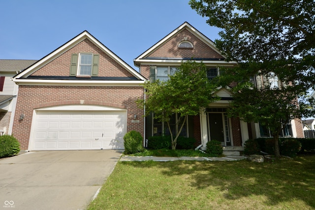 traditional-style house with brick siding, an attached garage, concrete driveway, and a front yard