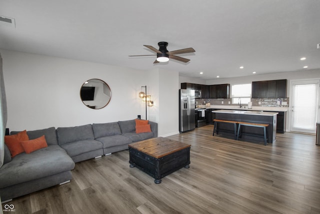 living room with recessed lighting, wood finished floors, visible vents, and ceiling fan