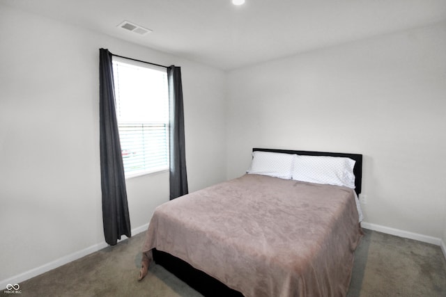 carpeted bedroom featuring visible vents and baseboards