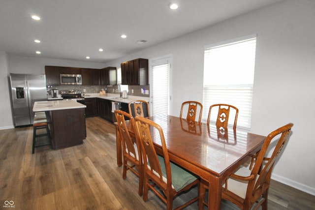 dining area with recessed lighting, baseboards, and dark wood finished floors