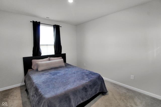 carpeted bedroom featuring visible vents and baseboards