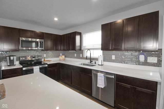 kitchen with a sink, light countertops, dark brown cabinetry, and stainless steel appliances