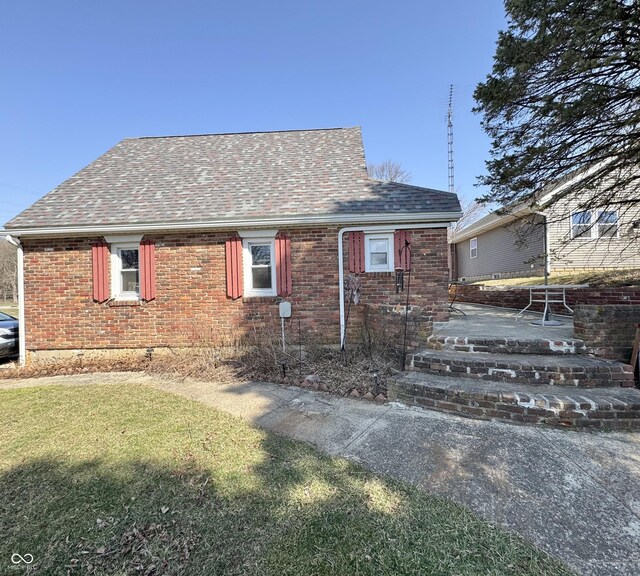 5395 W State Road 38, New Castle, IN 47362 - exterior space featuring brick siding, roof with shingles, a front lawn, and a patio area
