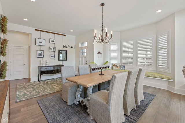 dining space featuring a notable chandelier, wood finished floors, recessed lighting, and baseboards