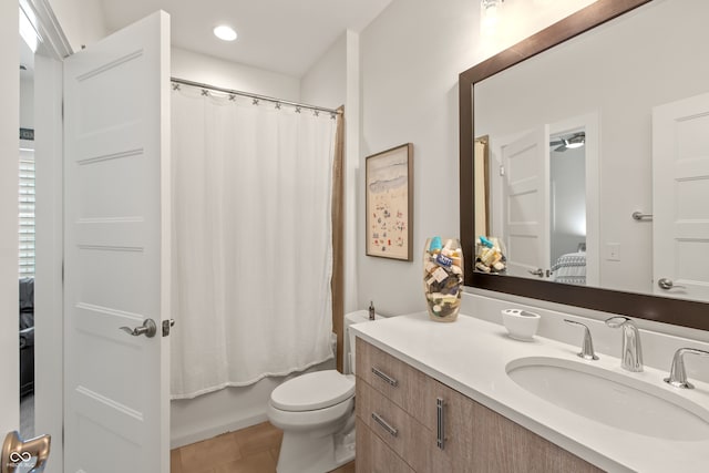 full bath with tile patterned flooring, toilet, shower / bath combo with shower curtain, recessed lighting, and vanity