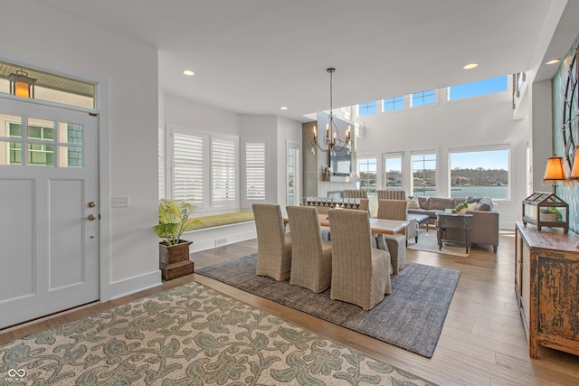 dining area featuring a notable chandelier, wood finished floors, recessed lighting, and baseboards